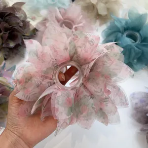 Primo piano di un elastico per capelli oversize con stampa floreale per acconciature eleganti.