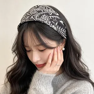 Close-up detail showing a vintage wide headband with elegant black and white pattern
