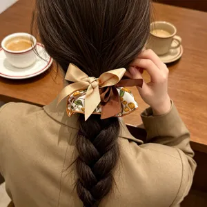 Detail view of a Korean style ribbon bow scrunchie styled on a braided ponytail