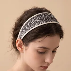 Detailed side view of a model wearing a retro leopard print wide mesh headband