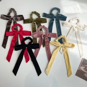 Collection of elegant velvet bow scrunchies with long ribbons on white background
