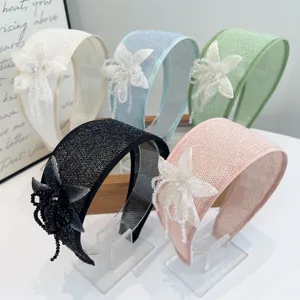 Five pastel colorful handmade beaded flower wide headbands displayed side by side