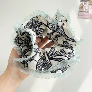Detailed view of oversized pleated hair scrunchie with mint green tulle ruffles