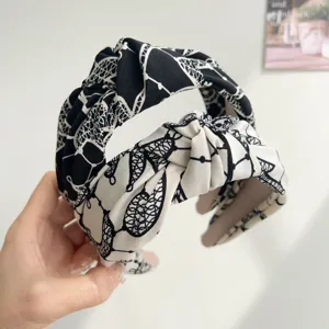 Detail showing the elegant ink floral pattern on these wide-brimmed fabric headbands
