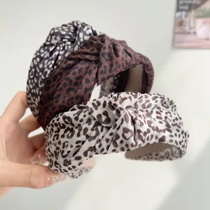 Detail view of three leopard print knot headbands showing high-quality fabric texture