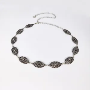 Stylish silver vintage metal waist chain with floral oval links for dresses and outfits.