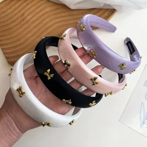 Detailed view of four satin sponge headbands with gold bow knots in diverse colors.
