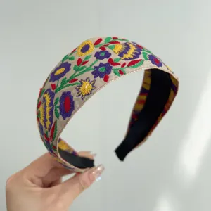 Detailed view of bohemian floral embroidered wide headband with vintage ethnic pattern