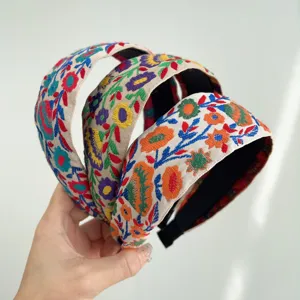 Detailed close-up showing three bohemian floral embroidered wide fabric headbands in ethnic style