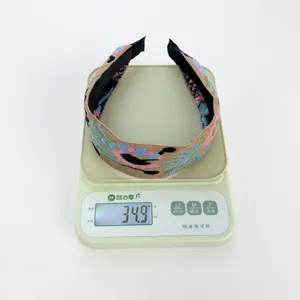Bohemian vintage ethnic style embroidered fabric wide headband showing 34.9g weight on scale