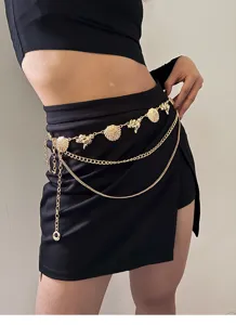 Gold shell waist chain detail showing delicate conch pendants and layered metal links.
