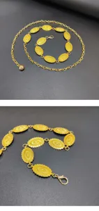 Detailed shot of retro gold tone metal waist chain with ornate oval carved medallions.