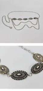 Close-up view of silver metal waist chain, retro carved oval conchos, multi-layer chain design.