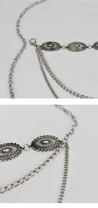 Detailed close-up view of silver metal waist chain, vintage style accessory for dresses.