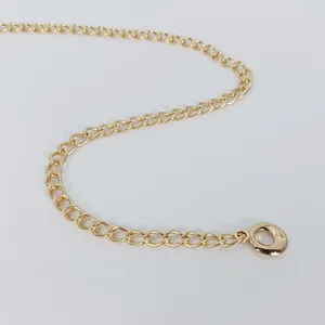 Gold metal chain accessory, delicate S-curve display on plain white background for styling.