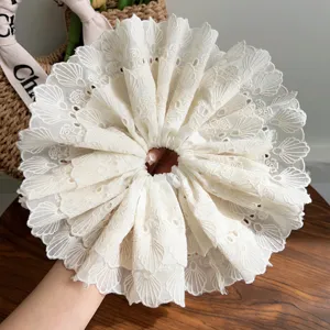 Close-up of white double-layered lace scrunchie with delicate embroidery