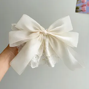 Large elegant cream lace bow hair clip with double-layered chiffon ribbon detail