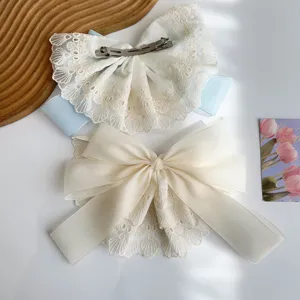 Detail view of oversized lace bow hair clips with elegant double-layer design
