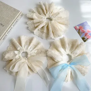 Close-up detail of oversized double-layer lace hair scrunchies with elegant organza bows