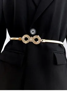 Gold metal elastic waist belt with sparkling rhinestone infinity buckle, dress accessory.
