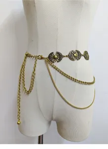 Dettaglio ravvicinato della catena da vita in metallo con motivo sole boho vintage.