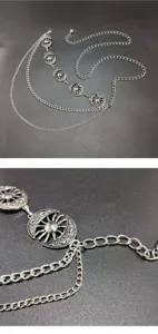 Dettaglio catena da vita argento retrò bohémien, elegante decoro corpo in metallo.