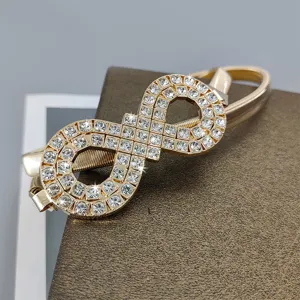 Gold elastic rhinestone waist belt for women, elegant metal dress accessory and sweater chain.