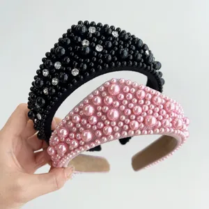 Dettaglio di cerchietti imbottiti decorati con perle nere e rosa e strass lucidi