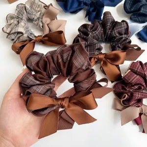 Close-up of Korean style plaid scrunchie with silk bow-knot hair tie details.