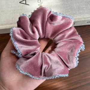 Nahaufnahme von rosa Samt Scrunchie mit Kristallperlen Details