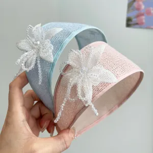 Detail shot of handmade beaded flower headband set in elegant pastel blue and pink