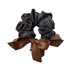 Elegant brown plaid fabric hair scrunchie with large ribbon bow for stylish ponytail