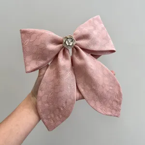 Elegant pink floral jacquard bow hair clip with pearl camellia flower detail