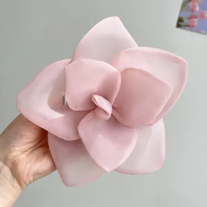 Detailed view of large pink mesh rose flower hair clip with delicate petal layers