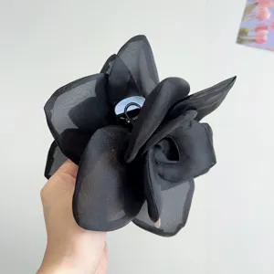 Large black mesh flower hair claw clip featuring elegant sheer fabric and romantic rose design