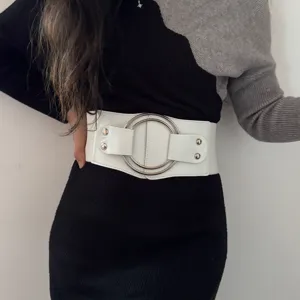 Women's wide elastic waist belt with metal double ring buckle and rivets, stylish main view.