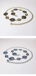 Detailed view of bohemian metal waist chains featuring round medallion patterns in gold and silver.