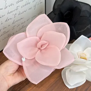 Detailed close-up showing the delicate mesh layers of an oversized pink rose hair clip