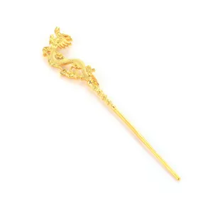 Macro view of a detailed golden dragon-shaped hairpin with intricate hollow carving