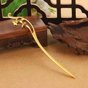 Detailed macro view of an elegant gold-toned hair stick with hollowed-out cloud motifs.