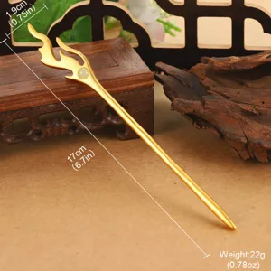Close-up of a 17cm golden traditional Chinese hair stick with elegant flame design.