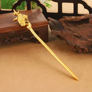 Detail view of a golden vintage Chinese hair stick with hollow flower design