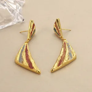 Detailansicht von goldenen Vintage-Ohrringen mit roten und blauen Emaille-Streifen-Akzenten