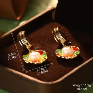 Detail of colorful enamel pearl earrings with measurement markings in jewelry box