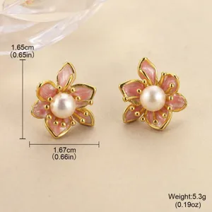 Macro view of pink enamel flower earrings with pearl centers and dimensions