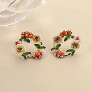 Macro detail of floral enamel wreath stud earrings with purple rhinestone centers