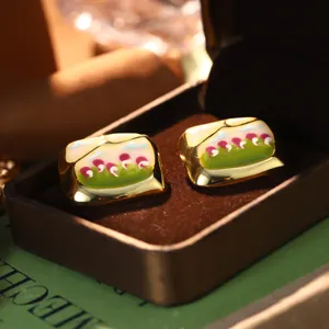 Detailed macro shot of vintage-style enamel oil painting flower earrings in a gift box