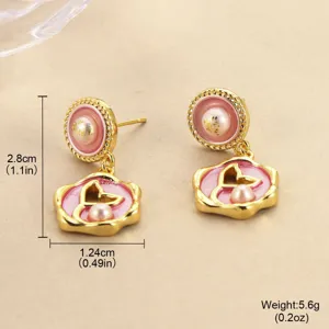 Detailed view of pink enamel butterfly earrings with dimensions 2.8cm and 1.24cm width