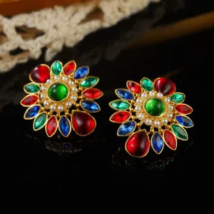 Detailed macro view of vintage court-style floral earrings with multi-color stones and pearls