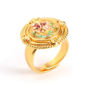 Close-up of vintage baroque gold ring with floral oil painting enamel detail